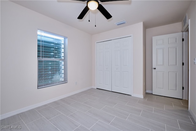 unfurnished bedroom featuring a closet and ceiling fan