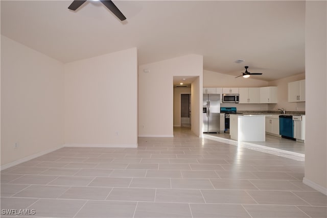 unfurnished living room with light tile patterned floors, ceiling fan, lofted ceiling, and sink