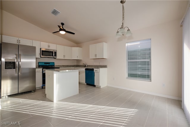 kitchen featuring a center island, lofted ceiling, white cabinets, decorative light fixtures, and stainless steel appliances