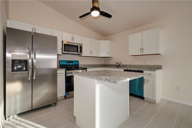 kitchen featuring a center island, white cabinets, vaulted ceiling, and appliances with stainless steel finishes