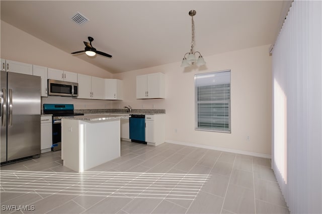 kitchen featuring a center island, pendant lighting, lofted ceiling, white cabinets, and appliances with stainless steel finishes