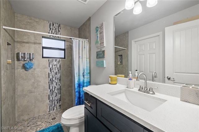 bathroom featuring a shower with curtain, toilet, and vanity