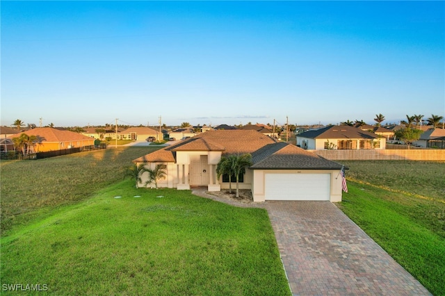 view of front facade featuring a garage and a front lawn