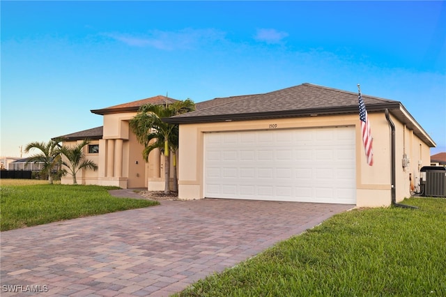 view of front of house with a front yard, a garage, and central air condition unit