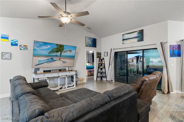 living room with ceiling fan, vaulted ceiling, and light wood-type flooring