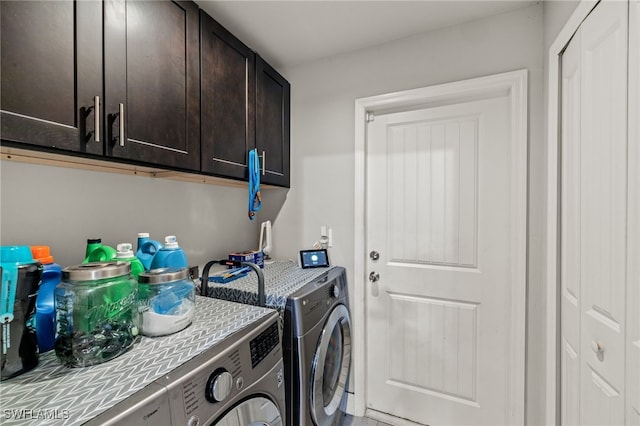 laundry area with washer and clothes dryer and cabinets