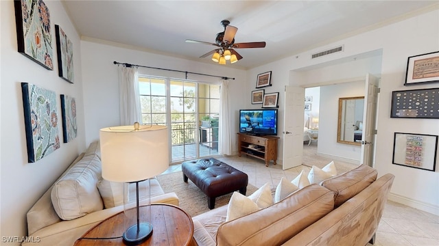 living room with ceiling fan, light tile patterned floors, and ornamental molding