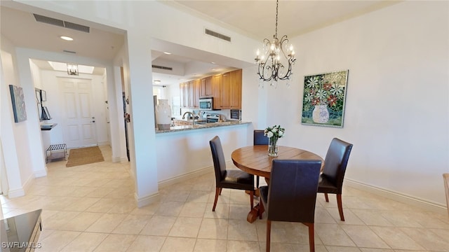 dining room with a chandelier and light tile patterned floors