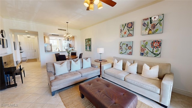 living room featuring ceiling fan with notable chandelier and light tile patterned floors