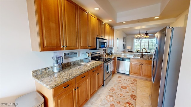 kitchen with hanging light fixtures, light tile patterned floors, light stone counters, stainless steel appliances, and a chandelier