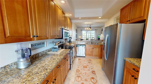 kitchen featuring sink, stainless steel appliances, light stone counters, a chandelier, and light tile patterned floors