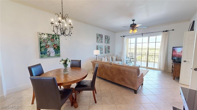 tiled dining area with ceiling fan with notable chandelier