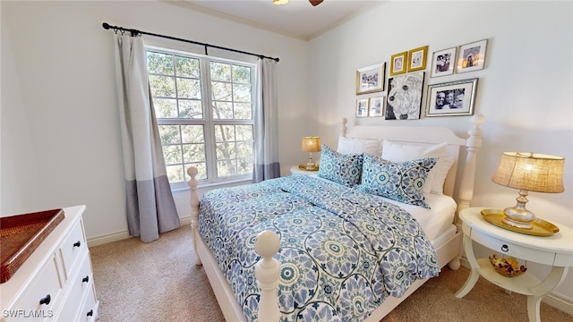 bedroom with ceiling fan, ornamental molding, and light carpet