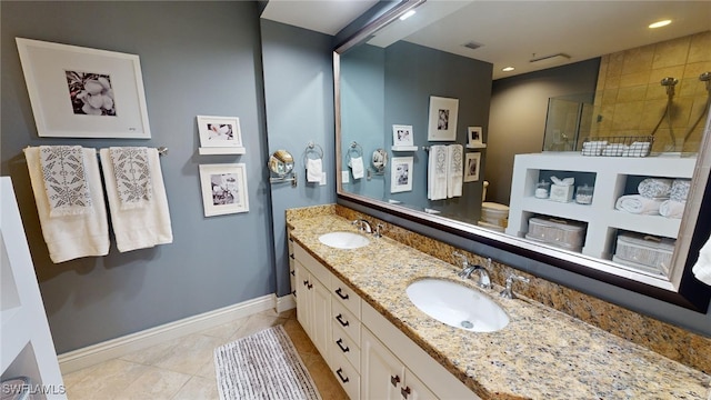 bathroom with tile patterned floors, vanity, toilet, and tiled shower