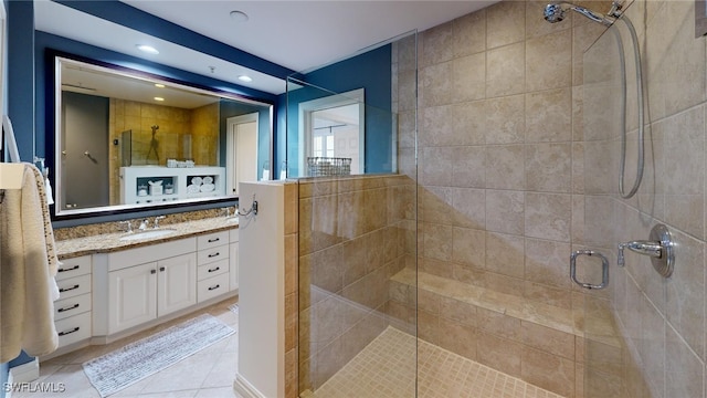 bathroom with vanity, tile patterned floors, and a shower with shower door