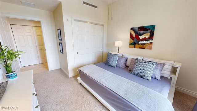 bedroom with light carpet and a closet