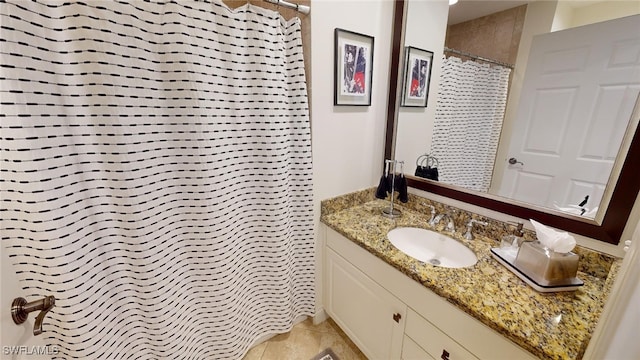 bathroom featuring tile patterned flooring, vanity, and a shower with curtain