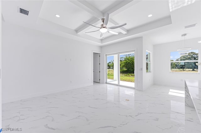 empty room with beamed ceiling, a raised ceiling, and ceiling fan