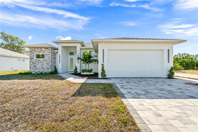 view of front facade with a front yard and a garage