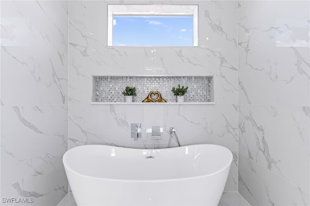 bathroom featuring tile walls and a bathing tub