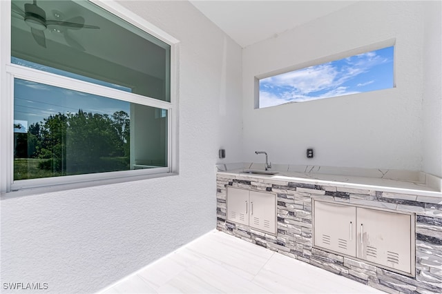 bathroom featuring ceiling fan and sink