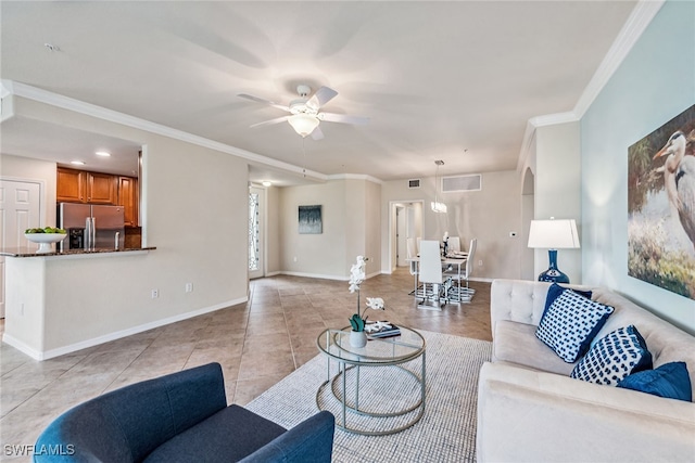 tiled living room featuring ceiling fan and crown molding