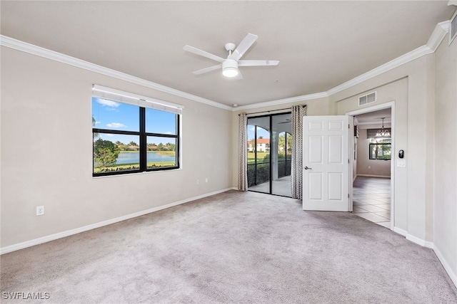 carpeted empty room featuring ceiling fan, a healthy amount of sunlight, and ornamental molding