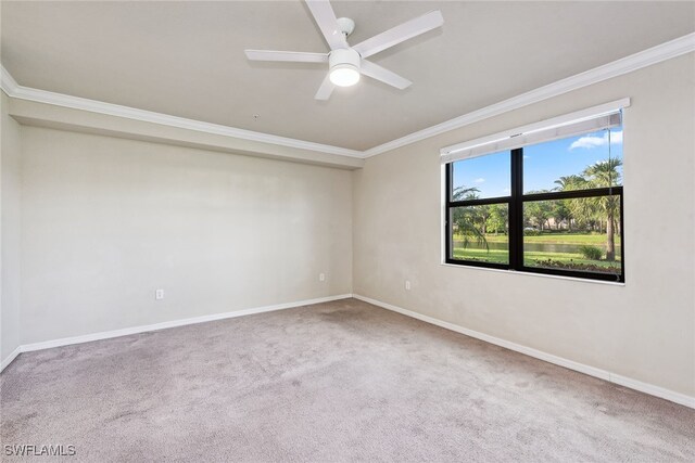 empty room featuring ceiling fan, carpet floors, and ornamental molding