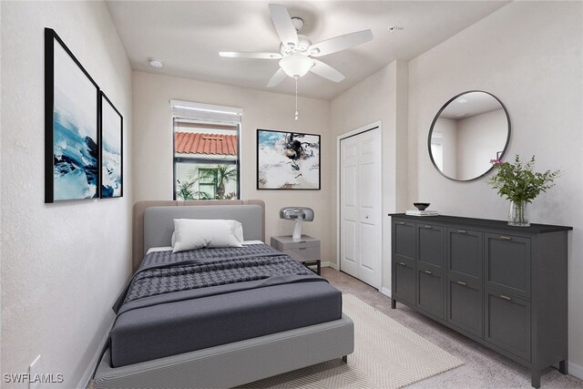 carpeted bedroom with a closet and ceiling fan