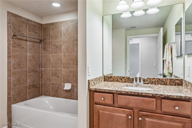 bathroom with vanity and tiled shower / bath combo