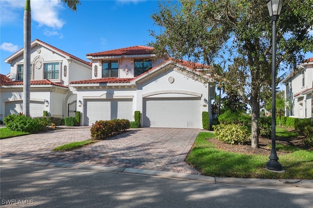 mediterranean / spanish-style house with a garage