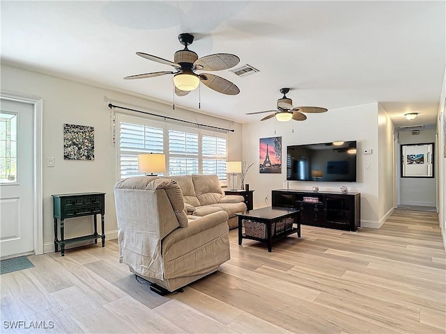 living room featuring ceiling fan and light wood-type flooring