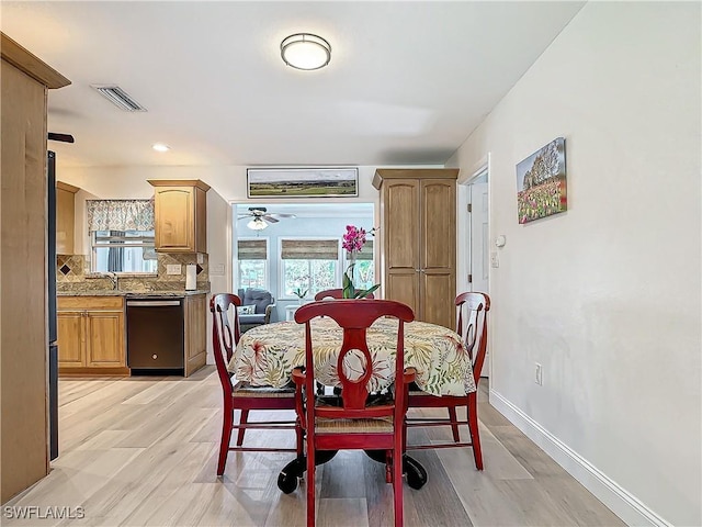 dining space featuring light hardwood / wood-style floors, ceiling fan, and sink