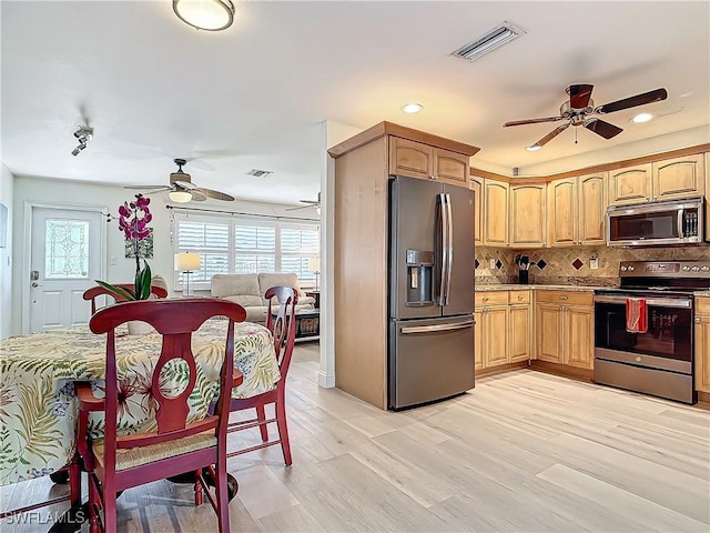 kitchen with ceiling fan, light hardwood / wood-style floors, backsplash, and appliances with stainless steel finishes