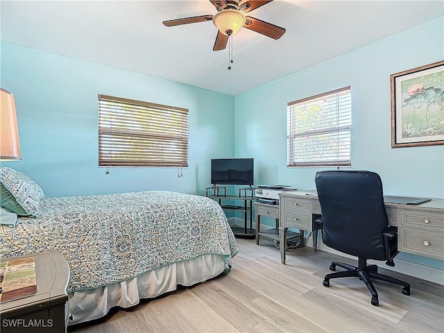 bedroom with ceiling fan and light hardwood / wood-style floors