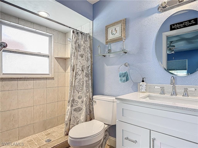 bathroom featuring ceiling fan, toilet, walk in shower, and vanity