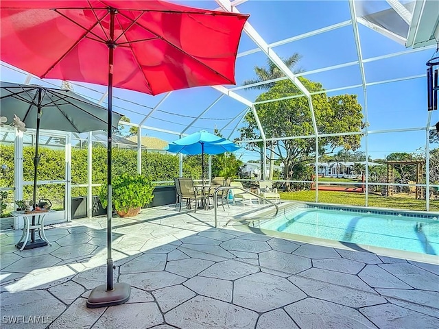 view of swimming pool featuring a lanai and a patio area