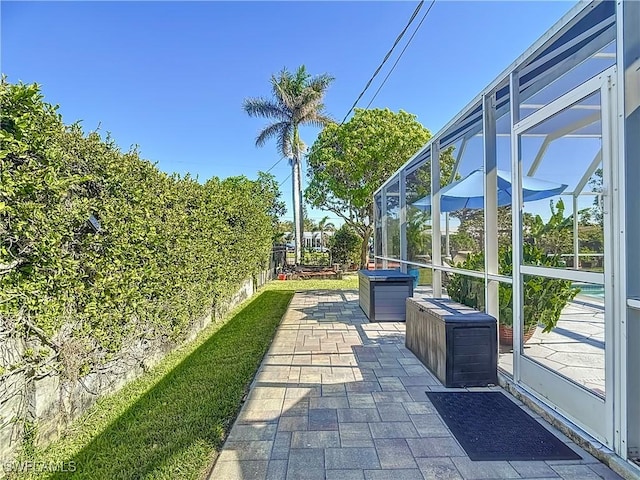 view of patio / terrace featuring glass enclosure