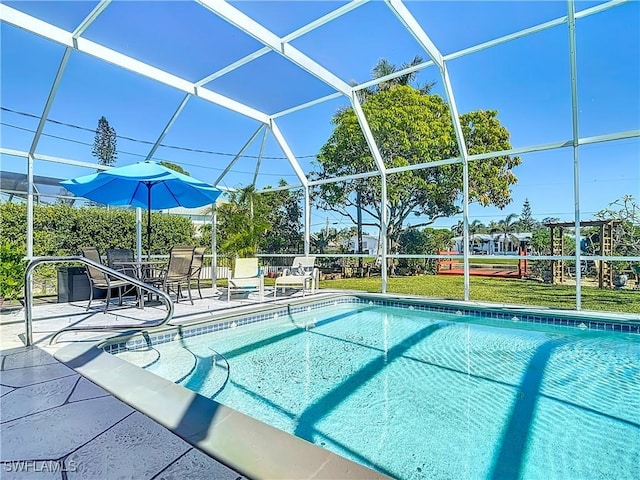 view of pool featuring glass enclosure and a patio