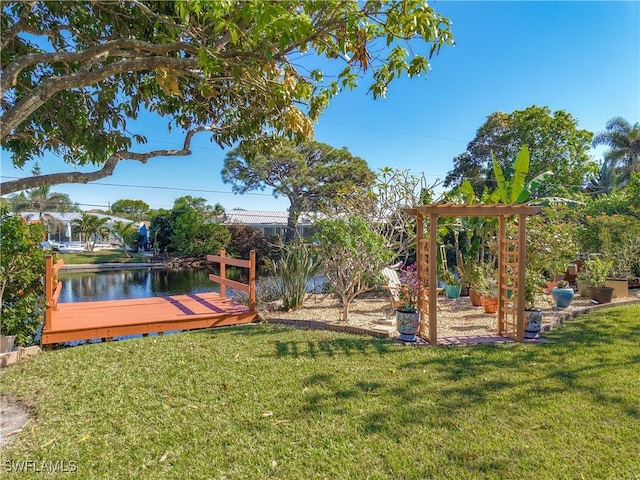 view of yard featuring a deck with water view