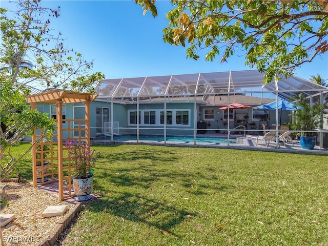 back of house with a lanai, a yard, and a patio