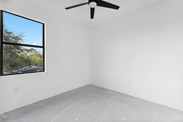 empty room with a wealth of natural light and ceiling fan