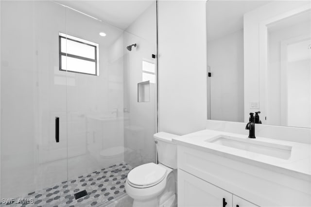 bathroom featuring walk in shower, tile patterned floors, vanity, and toilet