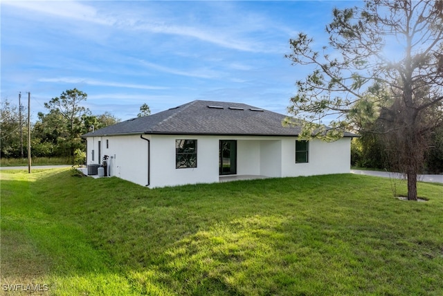 rear view of house featuring a yard and a patio