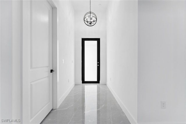 hallway featuring a notable chandelier