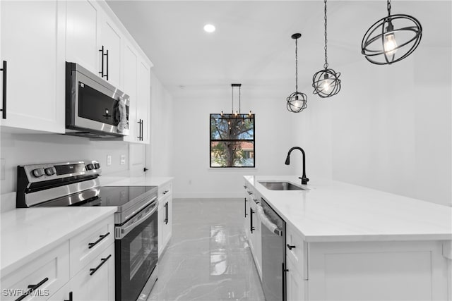 kitchen with white cabinets, stainless steel appliances, and decorative light fixtures