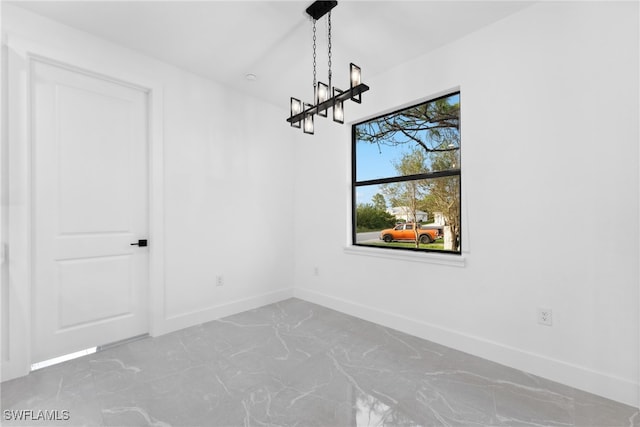 unfurnished dining area with an inviting chandelier