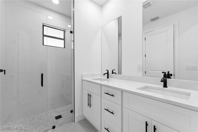 bathroom with vanity, tile patterned floors, and a shower with shower door