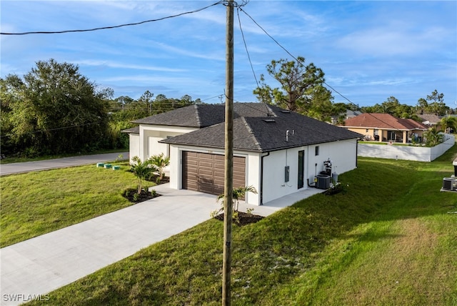 view of property exterior with a lawn and central AC