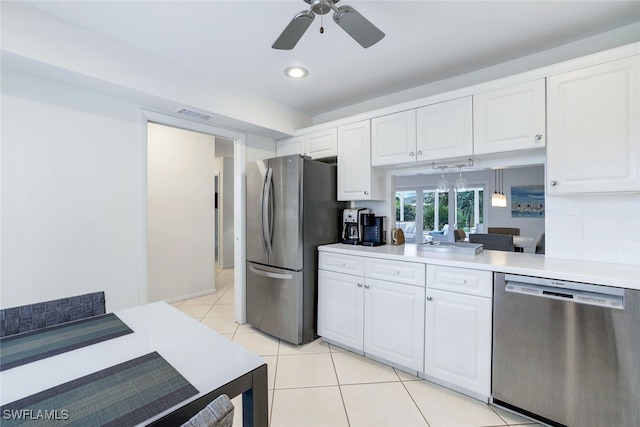 kitchen with white cabinets, appliances with stainless steel finishes, and ceiling fan